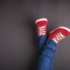 Feet concept - red shoes on black background with space for text or symbol